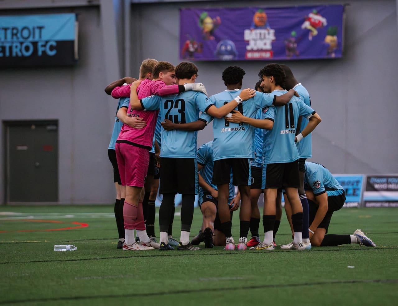 Detroit Metro FC players in a pre-match huddle